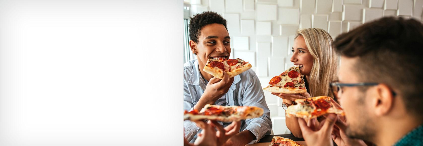 Friends enjoying pizza and laughing